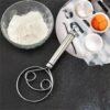 Steel flour cream mixer resting on a wooden kitchen countertop