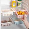 Fridge Organizer Basket on a refrigerator shelf holding fruits and vegetables