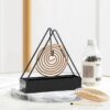 Coil holder in use preventing staining on a wooden surface