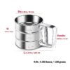 The flour sifter sitting on a kitchen countertop beside a bowl of sifted flour