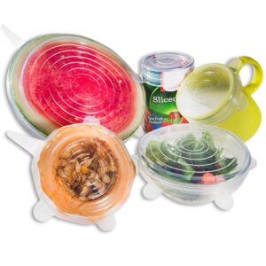 Clear silicone stretch lids covering various food containers, including a watermelon, a squash, and a salad.
