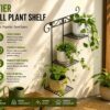 Black metal three-tier wall plant shelf on a white wall holding three potted plants